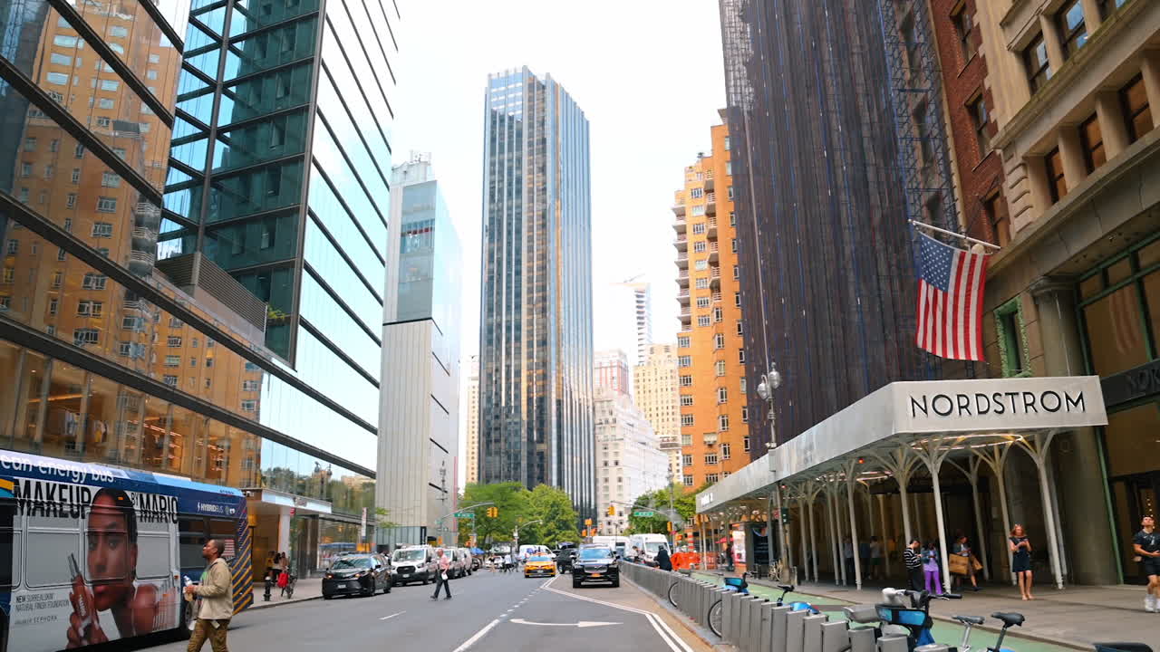 New York, USA, 1 August 2025: Modern glass buildings and Nordstrom store in the busy streets of New York City