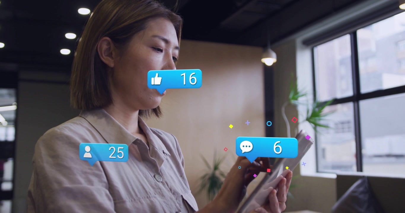 Woman tapping tablet and causing floating thumbs-up comment bubbles tracking rising social counts