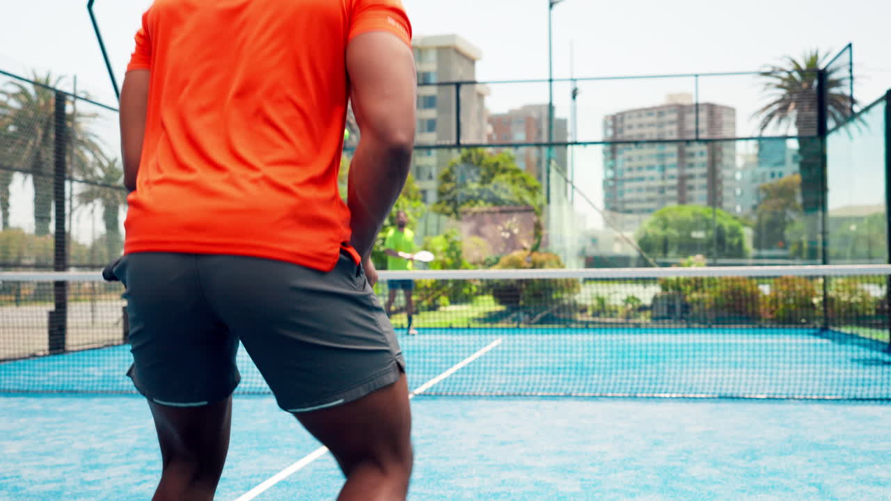 Padel Player Serving Ball on an Outdoor Blue Court