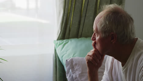 senior man in social distancing in his room of retirement house