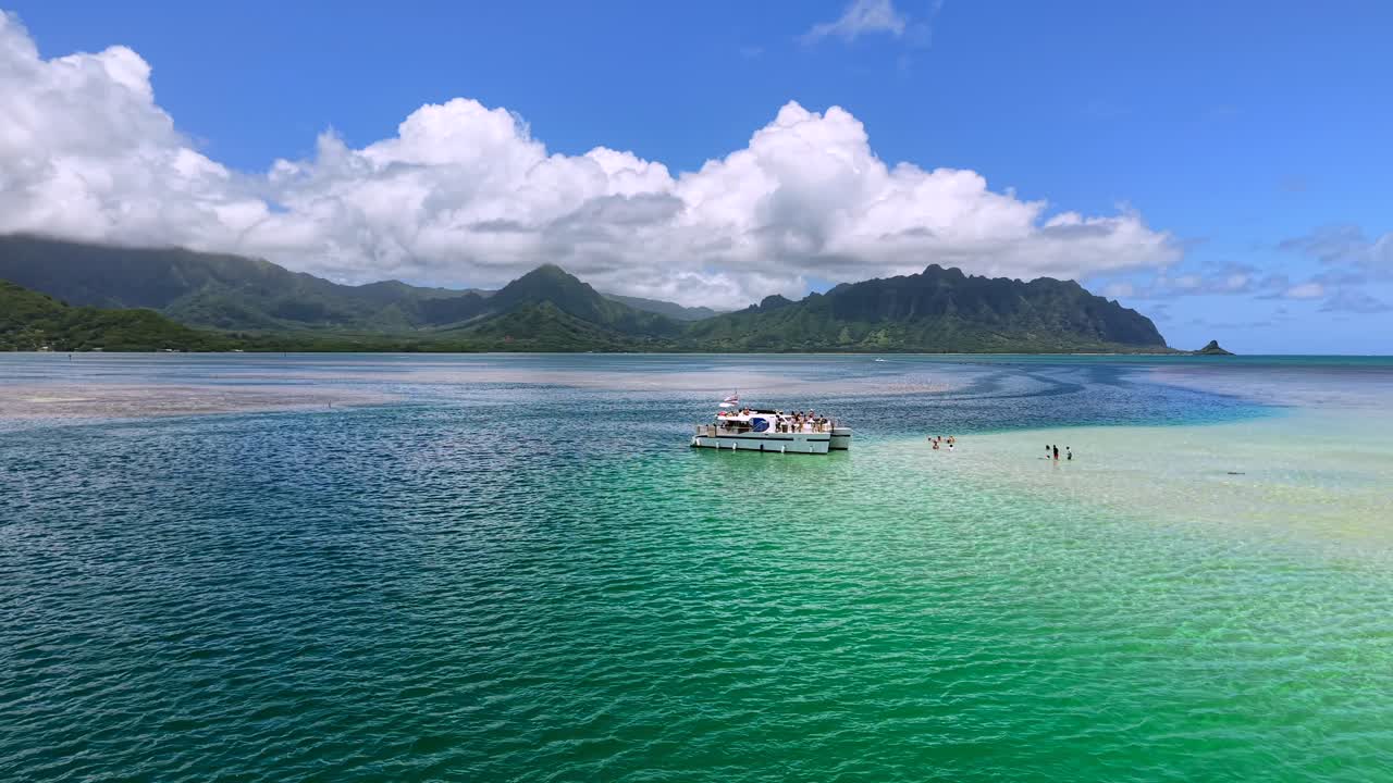 Catamaran Tour boat and swimmers in Kāne'ohe Bay on a Sunny Day in Oahu, Aerial