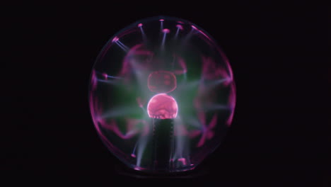 this is a close up video of a plasma globe running with a black background