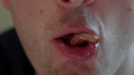 closeup of male mouth eating beef, detailed slow motion showing chewing, beef and fat on lips