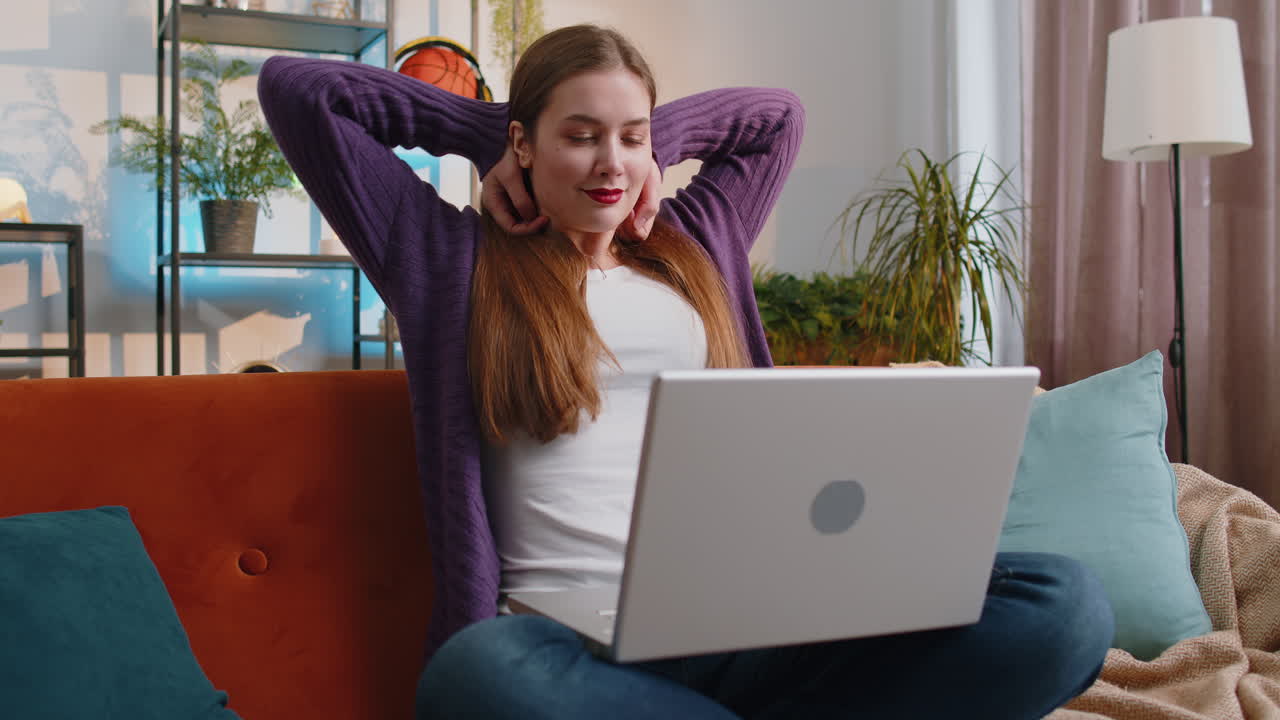 Pretty woman freelancer opens laptop starts working education sends messages makes online purchases