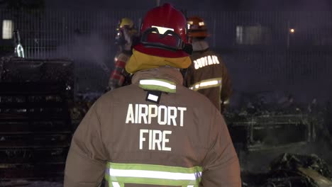 airport firefighter using fire gear