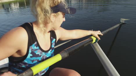 Female-rower-in-a-boat-on-a-river