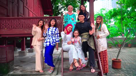 a group of malay people at the wooden house celebrating hari raya festive