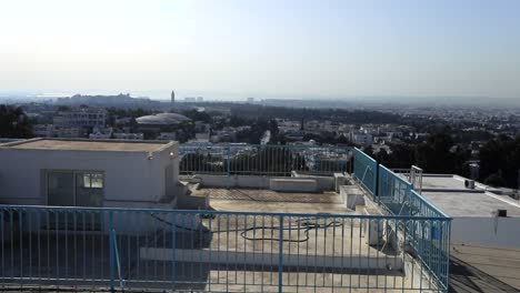 Sidi-bou-said-in-tunisia-showcasing-white-buildings-under-clear-skies,-aerial-view