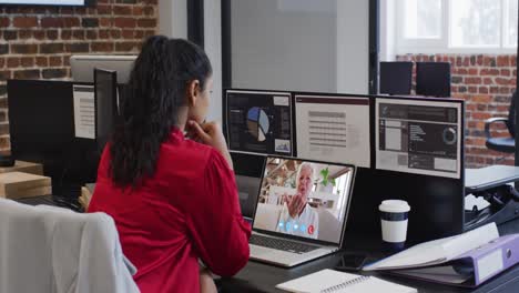 Caucasian-woman-on-laptop-video-chat-sitting-at-desk-in-office