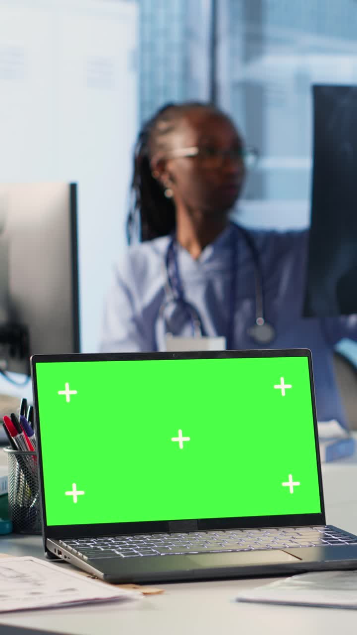 Doctor reviewing medical images on laptop