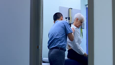 young asian male doctor examining a senior patient in the clinic 4k