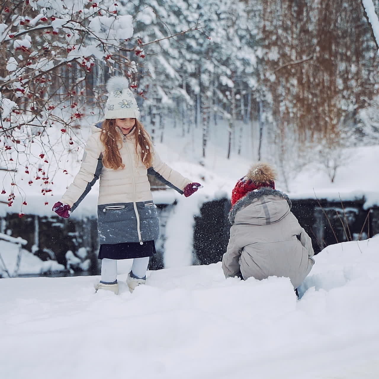 Children play outdoors in snow. Outdoor fun for family Christmas vacation.