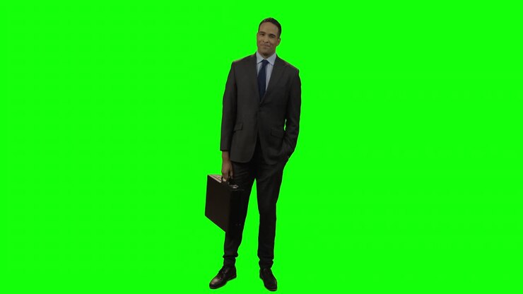 Portrait of smiling businessman standing with briefcase