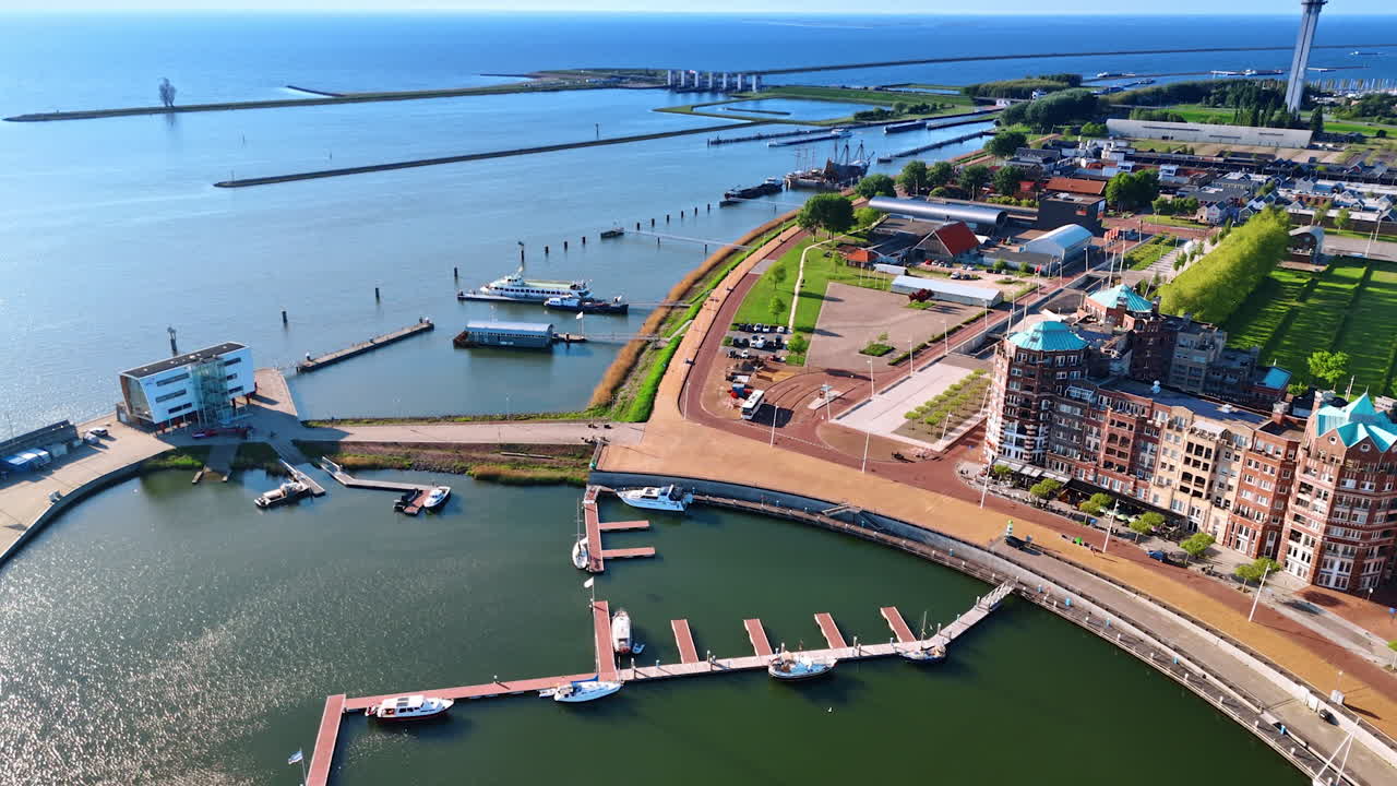 Spectacular coast of Lelystad,the Netherlands. Amazing marina with several boats and beautiful cityscape. Aerial view.