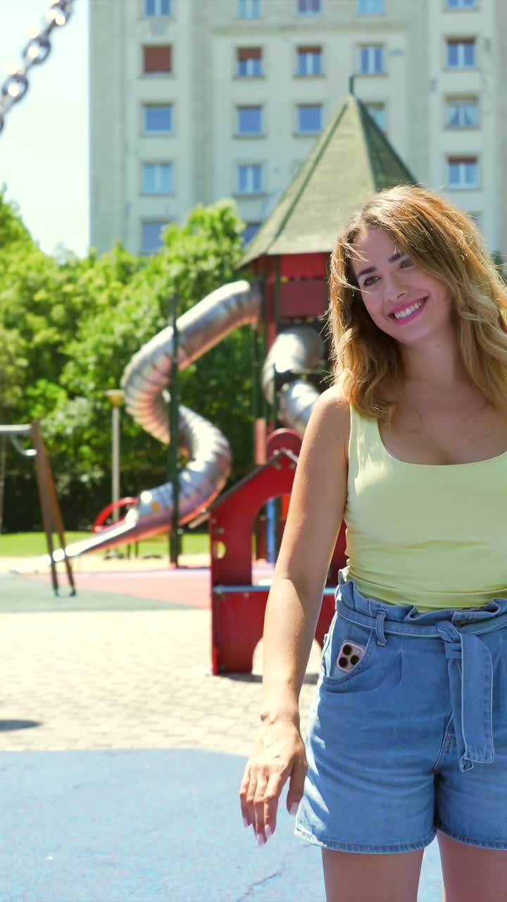 A woman enjoys a sunny day at the playground