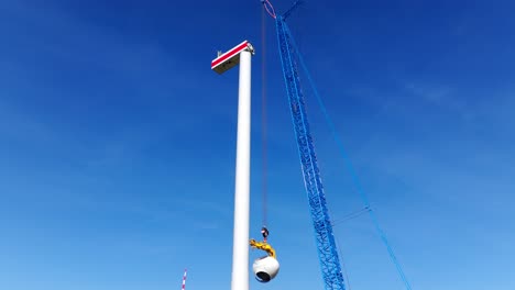 crane at the construction site of wind turbine at daytime