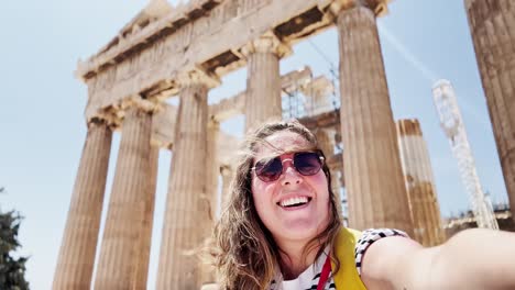 joyful woman laughing for a selfie at the parthenon, athens, greece