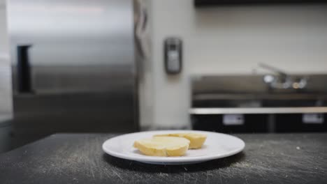 two pieces of toast being dropped on to a plate for breakfast as camera pans down