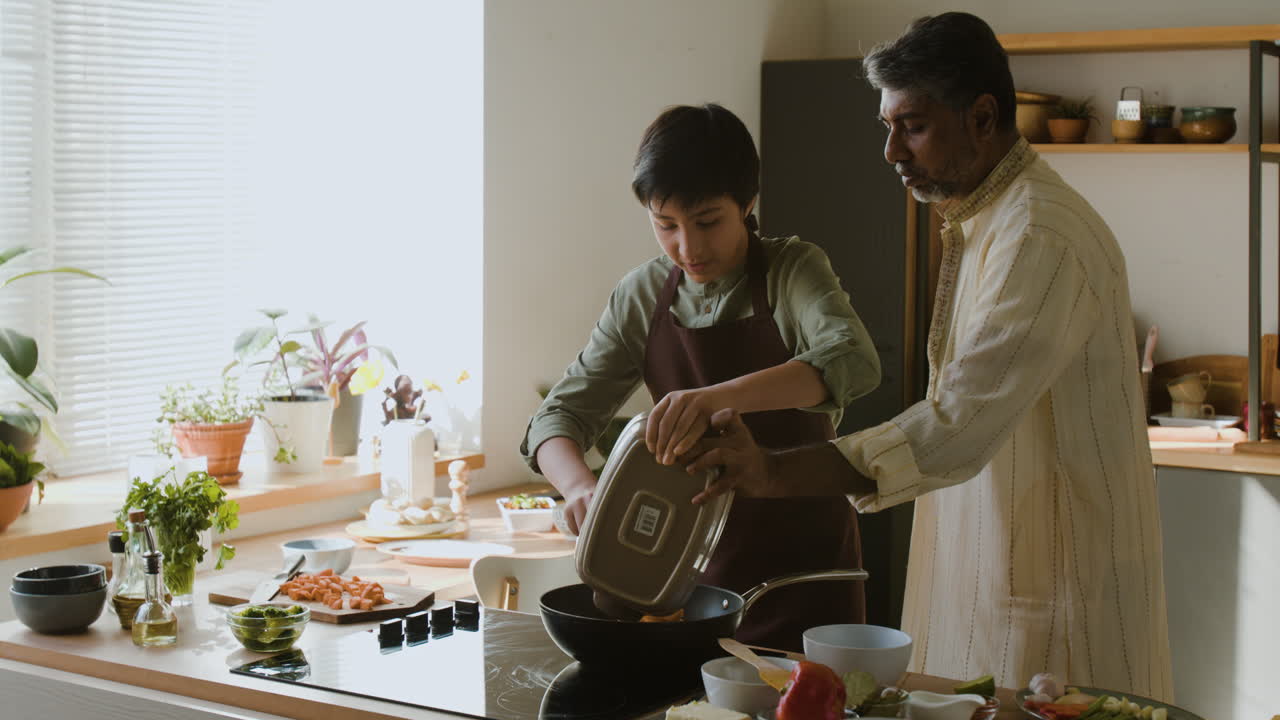 Father and Son Cooking Together in the Kitchen