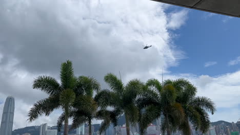 helicopter is flying around victoria harbour, hong kong
