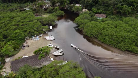 Aerial-view-following-a-boat-parking-on-the-sandy-coast-of-Rio-Sahy,-in-cloudy-Brazil