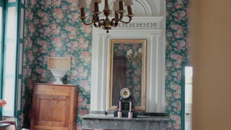 elegant room with floral wallpaper, vintage decor, and a large mirror