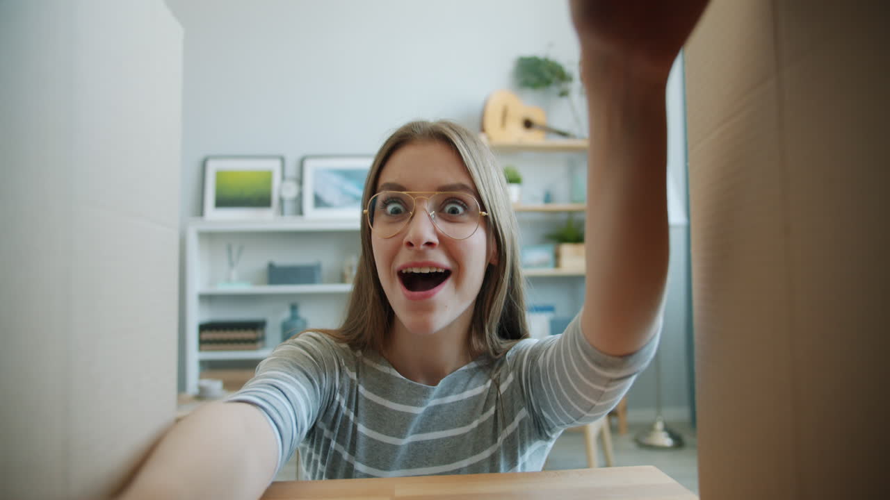 Excited Woman Unboxing a Gift or Moving Boxes