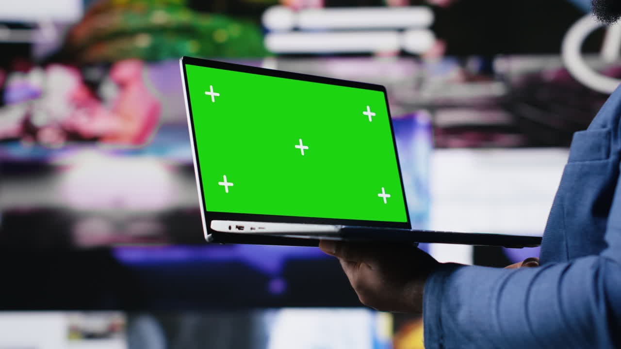 Modern black interface user holding a device with green screen
