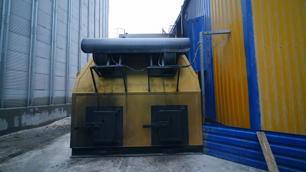 Diverse premises for storage and processing crops at large agricultural plant. Exterior of factory on processing grain crops.