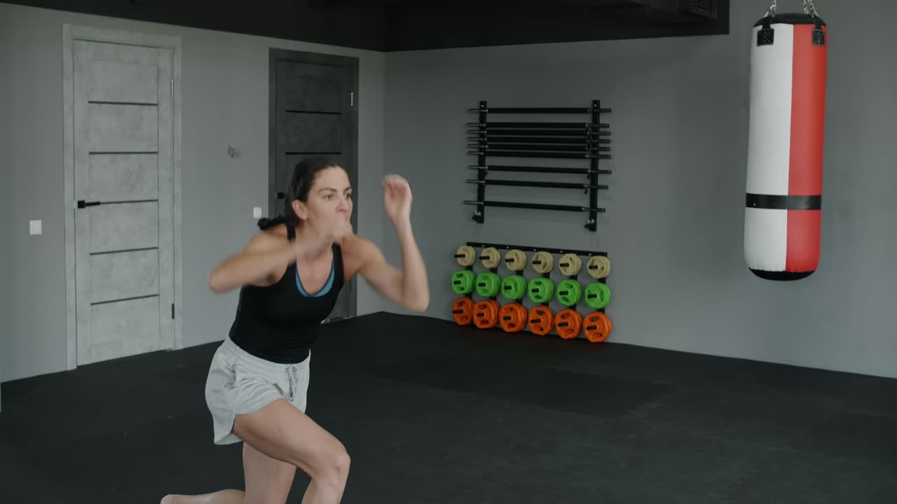 Woman Performing Squats in Gym