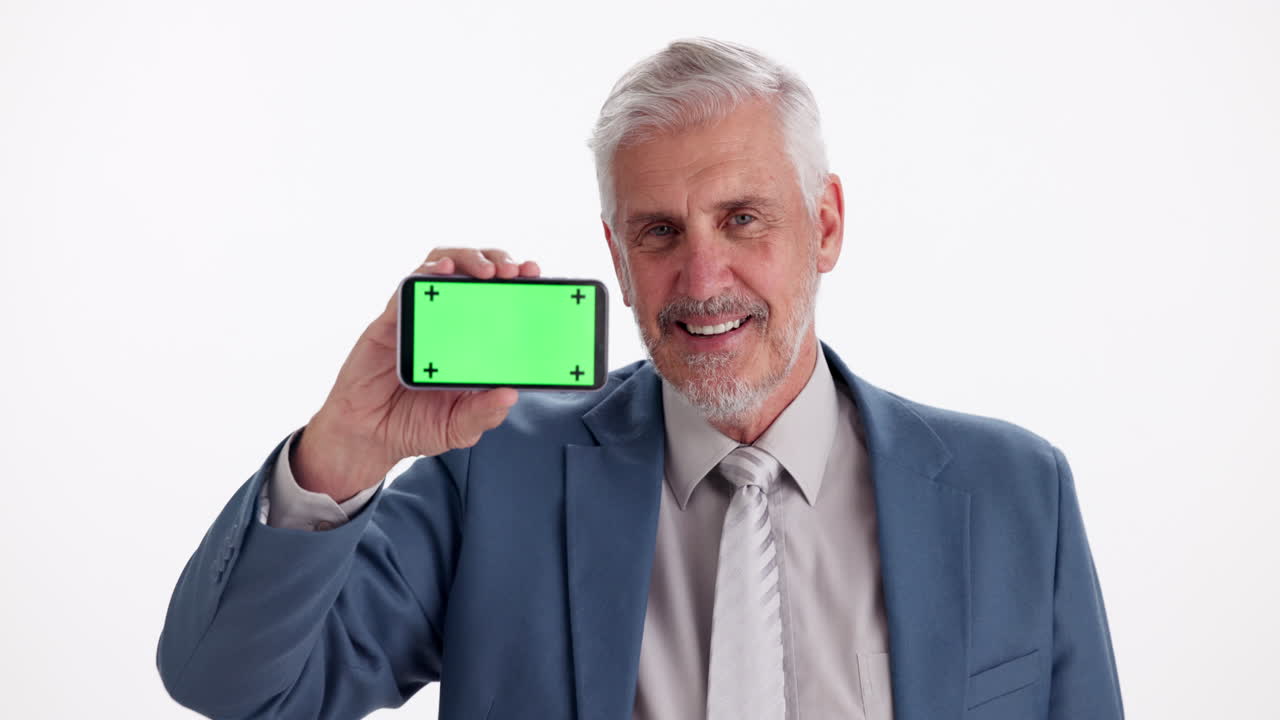Mature Businessman Holding Smartphone with Green Screen