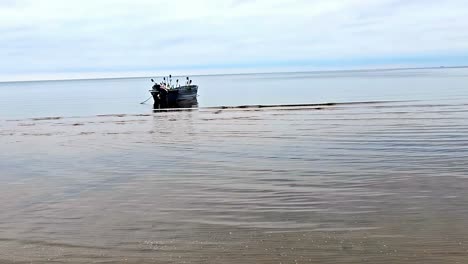 a fisherman boat is floating in the ocean without people on it