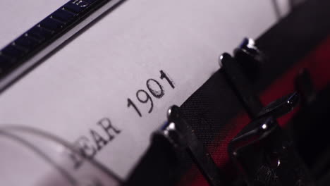 year 1901, typing on blank white paper in vintage typewriter, close up