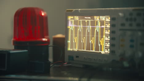 oscilloscope with red blinking light