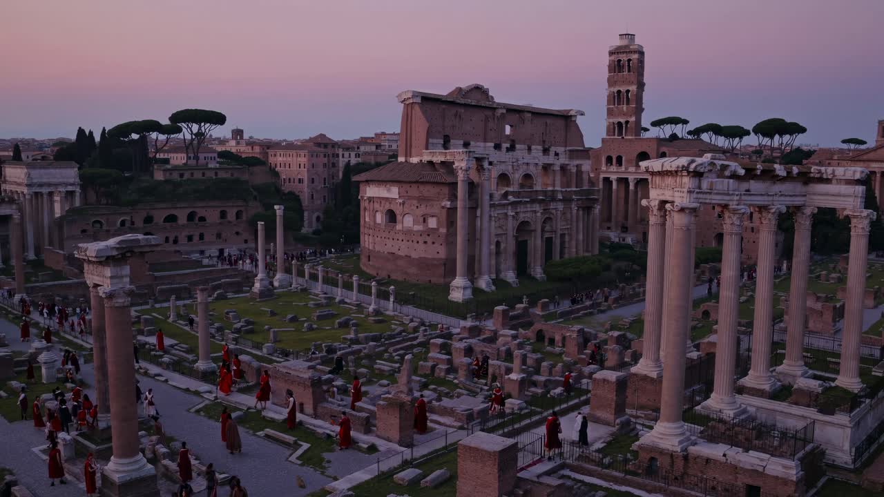 Aerial view of ancient Roman ruins at dusk, capturing historical architecture and vibrant sky