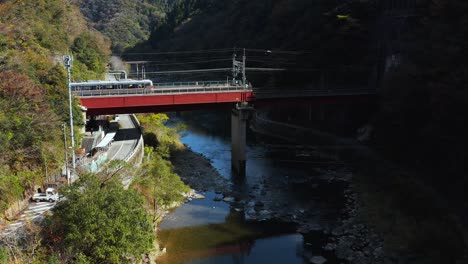 Takedao-JR-Train-Station-in-Hyogo,-Aerial-View-as-Train-Departs-Station