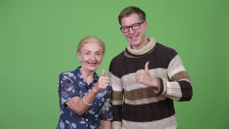 happy grandmother and grandson giving thumbs up together