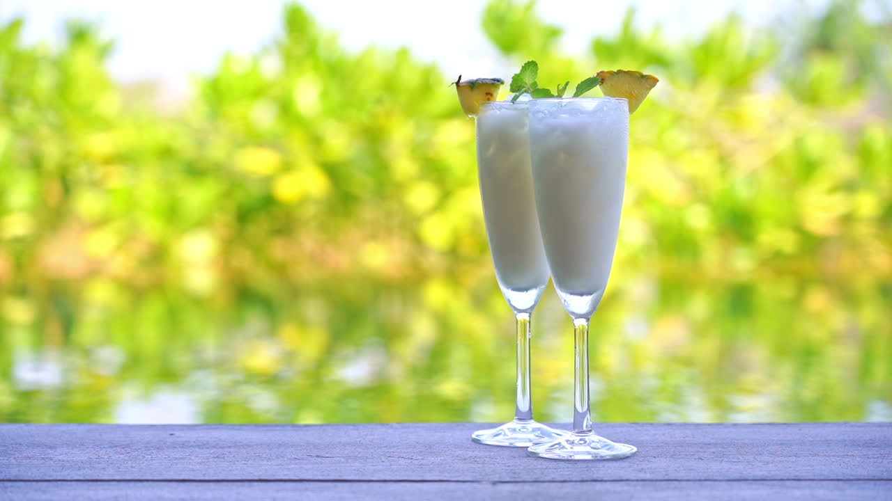 Close up two Tropical Cocktails with Blurred Background. Static