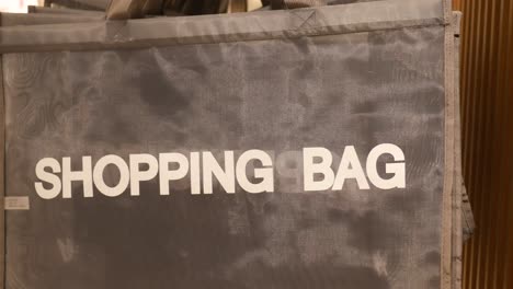 grey shopping bags displayed