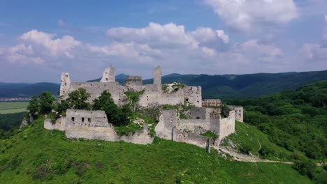 aerial footage of a ruined medieval castle on a hill, slovakia