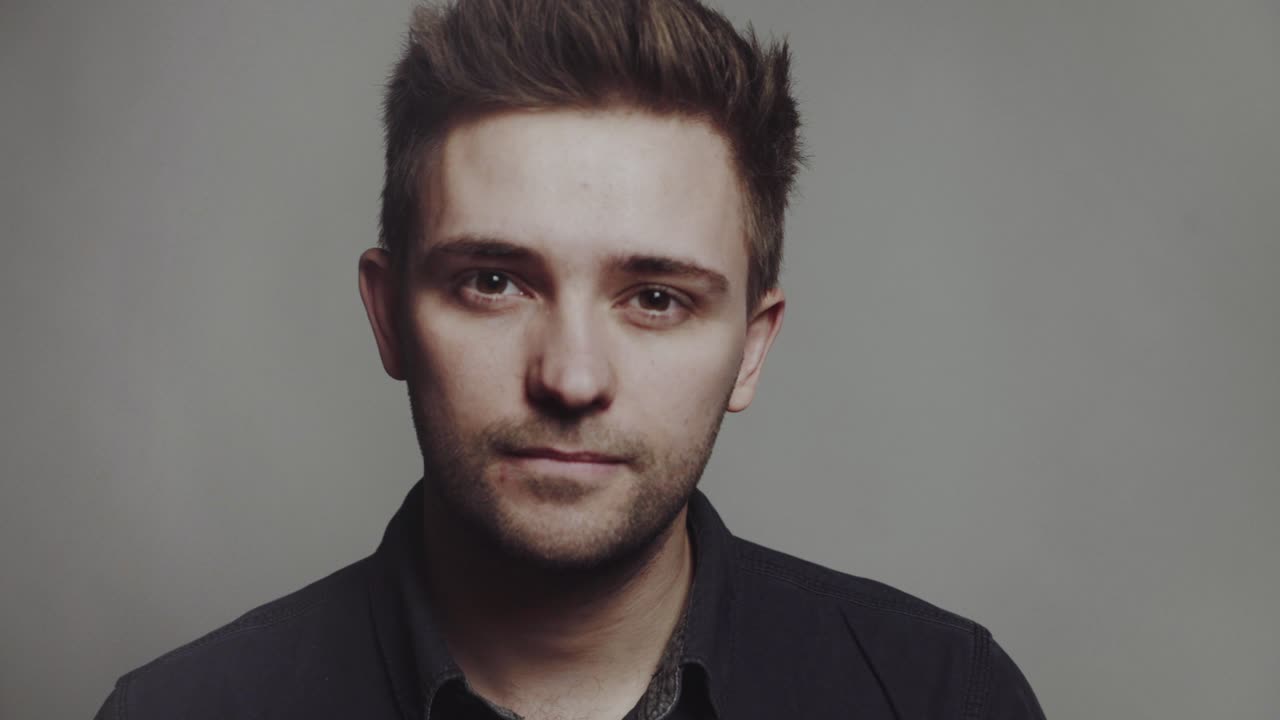 Fashion portrait of young man. Fashion portrait of young man in black shirt poses over wall