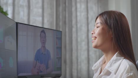 close up side view of asian female automotive designer having a meeting with a woman while working on 3d model of ev car on the desktop computers in the studio