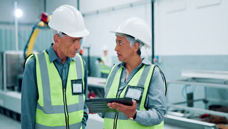 factory workers discussing procedures with robot