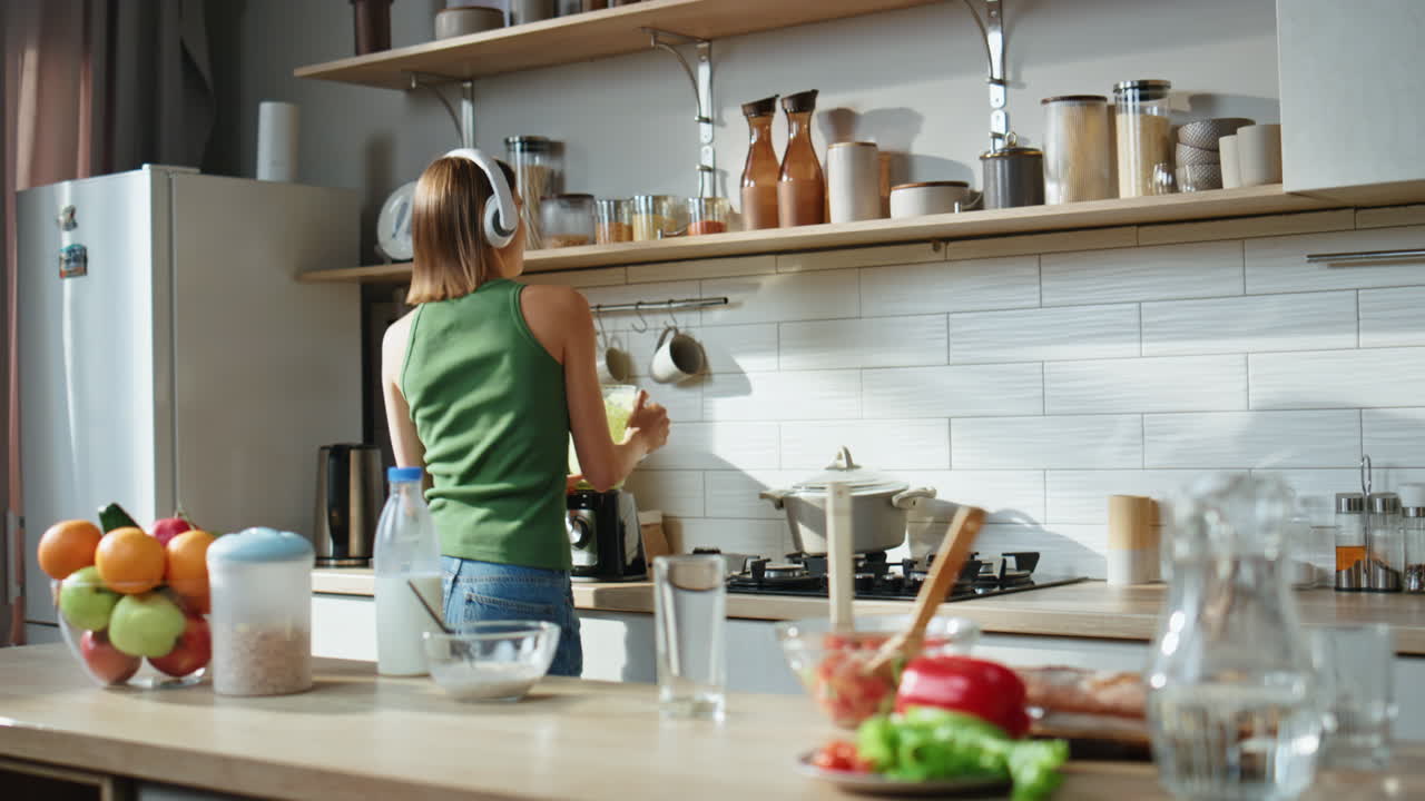 Woman making a smoothie in the kitchen