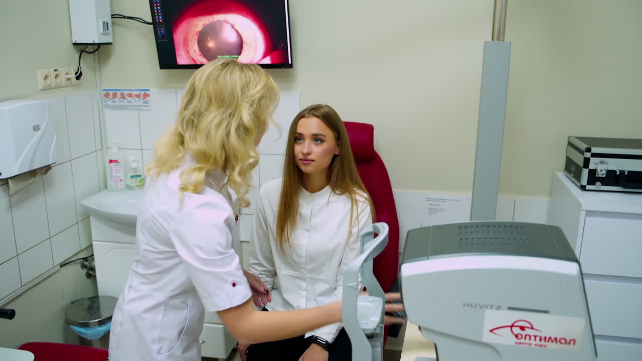 Doctor checking patient at eye clinic. Optometrist doing vision testing for patient in hospital