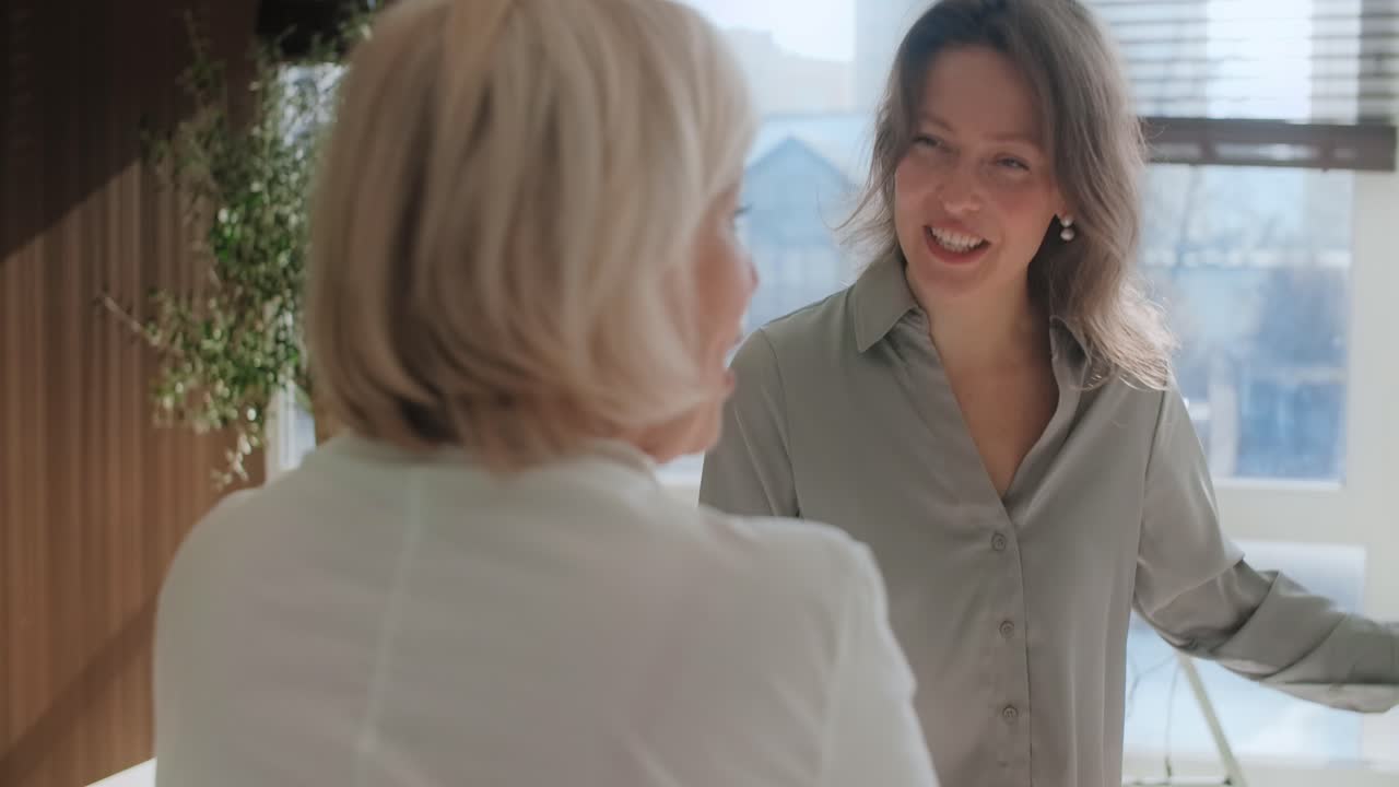 Two women having a conversation indoors