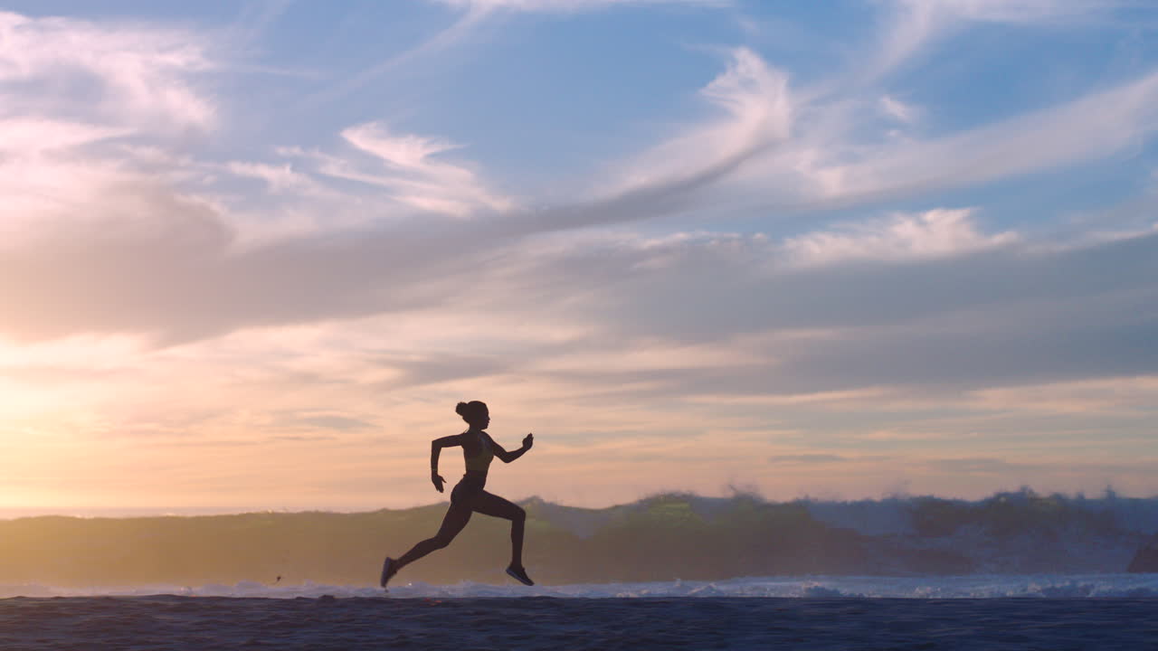 Active, fit and sporty athlete running on beach