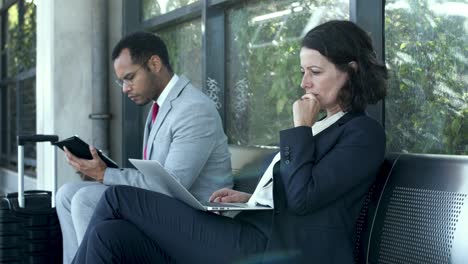 Businessman-and-businesswoman-with-digital-devices