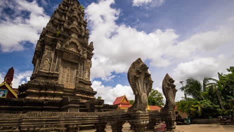 angkorian like temple structure with protective naga snake at the entrance