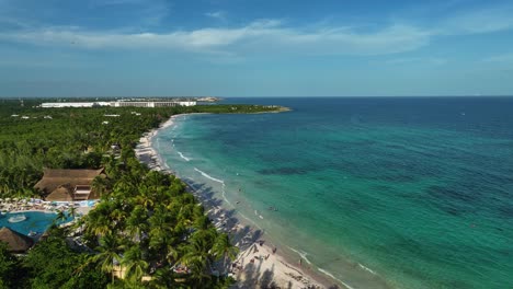 aerial view around calm waves at a tropical beach in xpu-ha, mexico - panoramic, drone shot